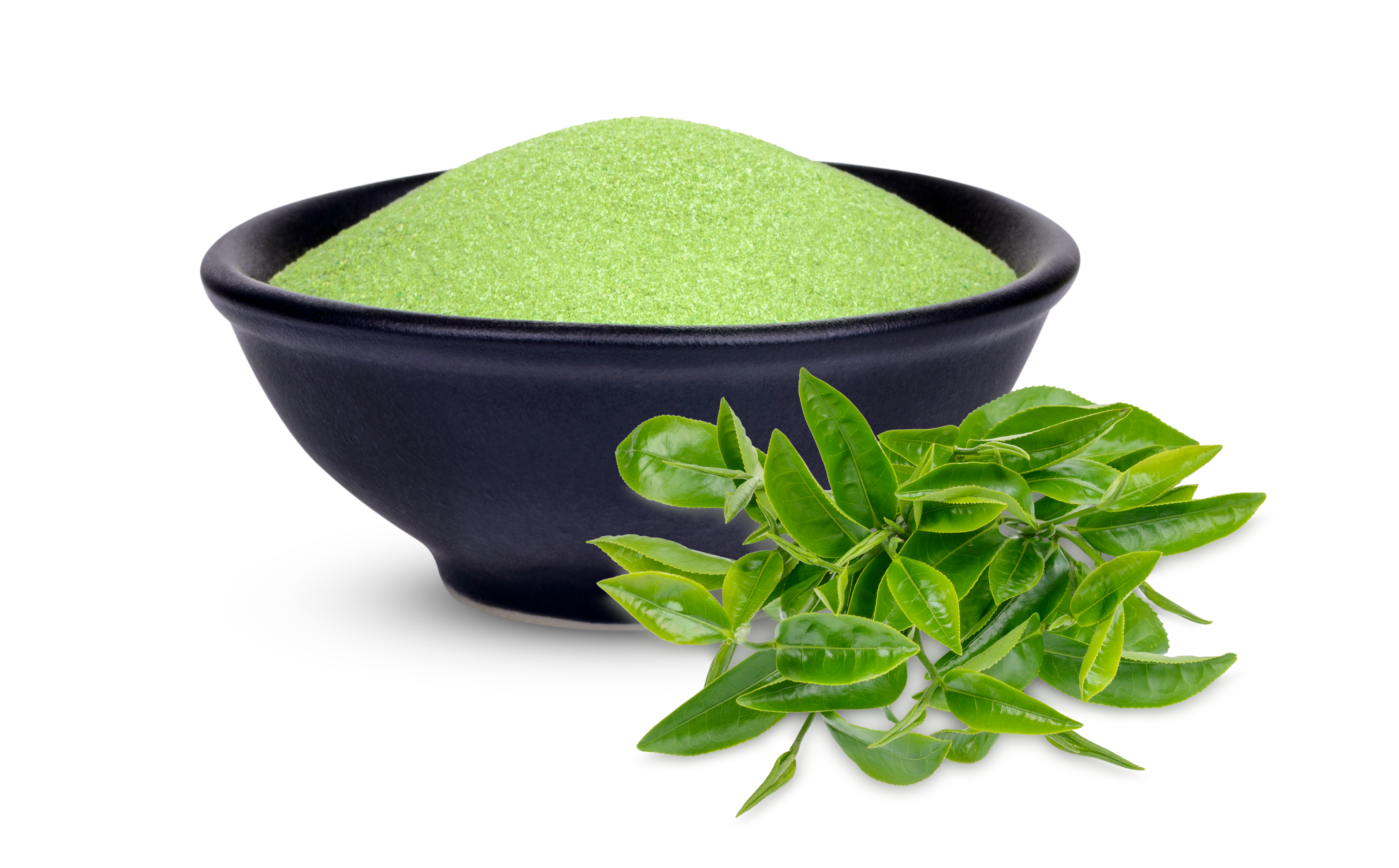 Natural green powder in black bowl with basil leaves